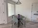 Cozy dining area with modern table and chairs, illuminated by a stylish pendant light at 13781 E Lehigh Ave # E, Aurora, CO 80014