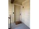 Unit E front door with welcome mat on a covered porch with neutral siding at 13781 E Lehigh Ave # E, Aurora, CO 80014