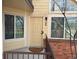 Charming front door with decorative windows, railing, and light fixture adds curb appeal to this home at 13781 E Lehigh Ave # E, Aurora, CO 80014