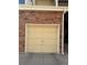 Garage door with brick accents provides secure parking and storage at 13781 E Lehigh Ave # E, Aurora, CO 80014