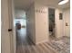 Hallway leading to various rooms showcasing neutral flooring and convenient closet space at 13781 E Lehigh Ave # E, Aurora, CO 80014
