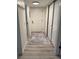 Entryway hallway with closet space and neutral flooring creating an inviting entrance at 13781 E Lehigh Ave # E, Aurora, CO 80014