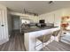 Well-equipped kitchen with stainless steel appliances, white cabinets, and a breakfast bar at 13781 E Lehigh Ave # E, Aurora, CO 80014