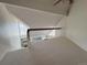 Open loft area with neutral carpeting and a railing overlooking the living space below at 13781 E Lehigh Ave # E, Aurora, CO 80014
