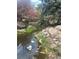Water feature includes mature landscaping around the edge with boulders and various plants at 13781 E Lehigh Ave # E, Aurora, CO 80014