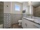 Stylish bathroom featuring patterned tile accents, granite countertop, and ample natural light from window at 31191 Black Eagle Dr # 304, Evergreen, CO 80439