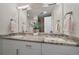 Bright bathroom with double vanity, granite countertops, large mirror, and modern fixtures at 31191 Black Eagle Dr # 304, Evergreen, CO 80439