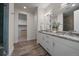 Well-lit bathroom with double vanity sinks, granite countertops and lots of storage at 31191 Black Eagle Dr # 304, Evergreen, CO 80439
