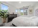 Bright bedroom with a large window, plant, and neutral décor for a calming and inviting atmosphere at 31191 Black Eagle Dr # 304, Evergreen, CO 80439