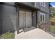 Inviting entryway featuring modern gray siding and convenient unit numbers at 31191 Black Eagle Dr # 304, Evergreen, CO 80439