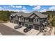 Modern gray townhome features private garages, balconies, and manicured landscaping at 31191 Black Eagle Dr # 304, Evergreen, CO 80439