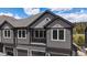 Charming townhome showcasing modern design, gray siding, and inviting curb appeal at 31191 Black Eagle Dr # 304, Evergreen, CO 80439