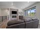 Bright living room with a stone fireplace, hardwood floors, and large windows at 31191 Black Eagle Dr # 304, Evergreen, CO 80439