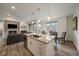 Open-concept living room with fireplace, kitchen island, and dining area filled with natural light at 31191 Black Eagle Dr # 304, Evergreen, CO 80439