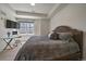 Comfortable bedroom featuring desk, neutral color palette, and view of the outdoors at 31191 Black Eagle Dr # 304, Evergreen, CO 80439
