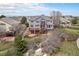 Expansive backyard with multi-level deck, patio, and lush greenery surrounding this beautiful home at 22090 E Arbor Dr, Aurora, CO 80016