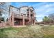 The backyard showcases a multi-level deck and brick pillars, perfect for outdoor entertaining at 22090 E Arbor Dr, Aurora, CO 80016