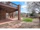 Covered patio offers a relaxing outdoor space with views of the landscaped backyard at 22090 E Arbor Dr, Aurora, CO 80016