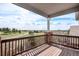Covered balcony with wood flooring and scenic golf course views at 22090 E Arbor Dr, Aurora, CO 80016