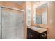 Bathroom featuring a walk-in shower, modern vanity with ample storage, and neutral color palette at 22090 E Arbor Dr, Aurora, CO 80016