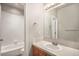 Traditional bathroom with white subway tile in shower, wood vanity with white countertop and a framed mirror at 22090 E Arbor Dr, Aurora, CO 80016