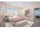Cozy bedroom with a large window, soft pink walls, and a comfortable bed adorned with decorative pillows at 22090 E Arbor Dr, Aurora, CO 80016