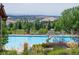 Community pool with a slide, lounge chairs, and views of the neighborhood at 22090 E Arbor Dr, Aurora, CO 80016