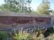 Stone community sign surrounded by plants and greenery at 22090 E Arbor Dr, Aurora, CO 80016