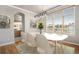Bright dining room featuring a marble table set, elegant lighting, and large windows with views at 22090 E Arbor Dr, Aurora, CO 80016