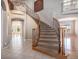 Elegant foyer with curved staircase, wrought iron railings, and tile flooring at 22090 E Arbor Dr, Aurora, CO 80016