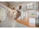 Grand foyer with high ceilings, elegant staircase, and a mix of hardwood and tile flooring at 22090 E Arbor Dr, Aurora, CO 80016