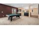 Spacious game room with a pool table, bar area, carpet flooring, and natural light from the windows at 22090 E Arbor Dr, Aurora, CO 80016
