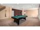 Open game room featuring a pool table, neutral paint colors, and large windows for plenty of natural light at 22090 E Arbor Dr, Aurora, CO 80016
