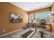 Bright home gym featuring fitness equipment, a TV, and large windows offering plenty of natural light at 22090 E Arbor Dr, Aurora, CO 80016