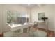 Bright home office with desk, chairs, computer, and large window overlooking trees at 22090 E Arbor Dr, Aurora, CO 80016