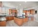Spacious kitchen featuring a center island with gas cooktop, granite counters, and stainless steel appliances at 22090 E Arbor Dr, Aurora, CO 80016