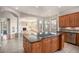 Open kitchen area with an island cooktop, granite counters, and views into living room at 22090 E Arbor Dr, Aurora, CO 80016