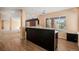 Spacious kitchenette features dark wood cabinetry, granite countertops, wood flooring and modern pendant lighting at 22090 E Arbor Dr, Aurora, CO 80016