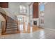 Spacious living room featuring a fireplace, large windows, and beautiful hardwood flooring at 22090 E Arbor Dr, Aurora, CO 80016