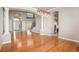 Open-concept living area with hardwood floors, columns, and views of the entry and staircase at 22090 E Arbor Dr, Aurora, CO 80016