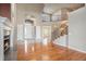 Bright and open living space with fireplace, large windows, and elegant staircase at 22090 E Arbor Dr, Aurora, CO 80016