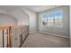 Spacious carpeted loft area with a large window and natural light at 22090 E Arbor Dr, Aurora, CO 80016