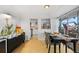 Well-lit dining area with a view of the kitchen and balcony through sliding glass doors at 800 N Washington St # 710, Denver, CO 80203
