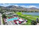 Beautiful aerial view features a luxurious community pool, picturesque golf course, lake, and mountain backdrop at 16631 Red Cliff Cir, Morrison, CO 80465