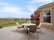 Outdoor deck featuring patio table and chairs with picturesque views of landscaping, open green space, and mountains at 16631 Red Cliff Cir, Morrison, CO 80465