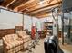Unfinished basement with exposed ceiling, chairs, table, and utility infrastructure, offering potential for customization at 16631 Red Cliff Cir, Morrison, CO 80465