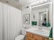 Cozy bathroom featuring a shower, toilet, sink and well-lit mirror at 16631 Red Cliff Cir, Morrison, CO 80465