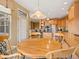 Open breakfast nook showcasing wood table and chairs adjacent to a bright, modern kitchen with stainless steel appliances at 16631 Red Cliff Cir, Morrison, CO 80465