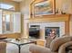 Close up of fireplace and mantle with decorations and artwork at 16631 Red Cliff Cir, Morrison, CO 80465