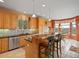 Well-lit kitchen with granite counters, stainless steel appliances, and breakfast bar at 16631 Red Cliff Cir, Morrison, CO 80465